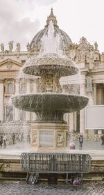 Fountain and building against sky