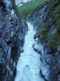 Scenic view of river amidst mountains against sky