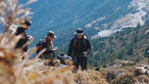 People on landscape against mountains