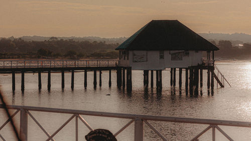 Pier over sea against sky during sunset