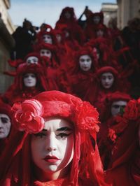 Close-up portrait of woman with red mask