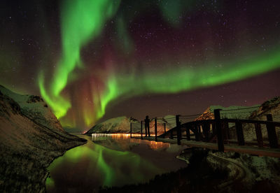 Scenic view of lake against sky at night