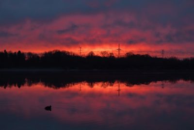 Scenic view of lake against romantic sky at sunset