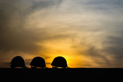 Low angle view of silhouette land against sky at sunset