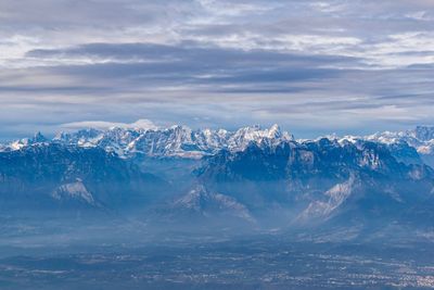 Aerial view of snowcapped mountains against sky