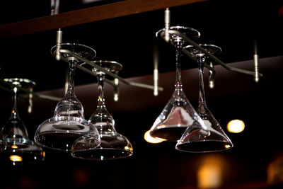 Close-up of wineglasses hanging in restaurant