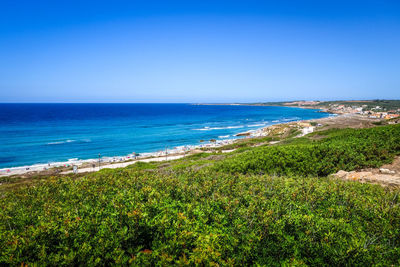 Scenic view of sea against clear blue sky