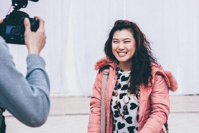 Portrait of smiling woman holding camera