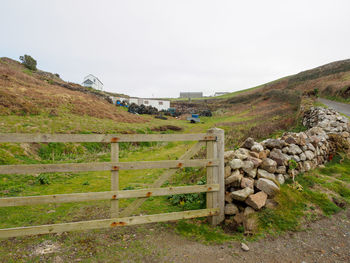 Fence on field against sky