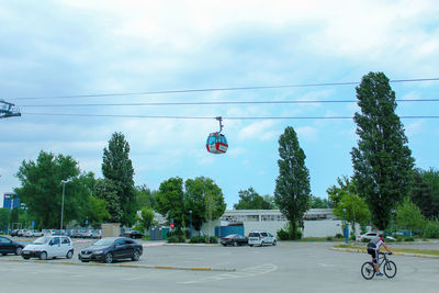 Cars on street against sky