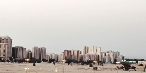 Panoramic view of buildings in city against clear sky