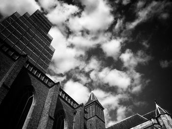 Low angle view of building against cloudy sky