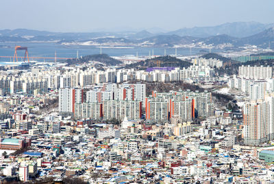 High angle view of city buildings against sky