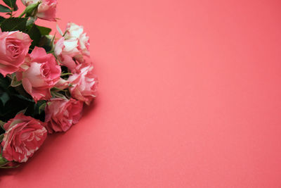 Close-up of rose bouquet against red background