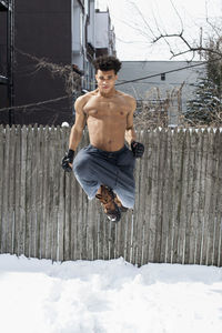 Young male boxer posing in the snow