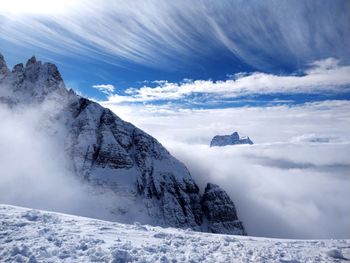 Scenic view of snowcapped mountains and cloudscape
