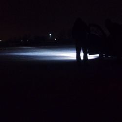 Blurred motion of woman in dark room