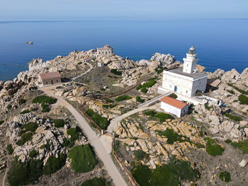 High angle view of townscape by sea against sky