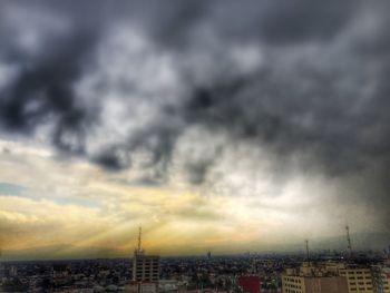 Cityscape against cloudy sky