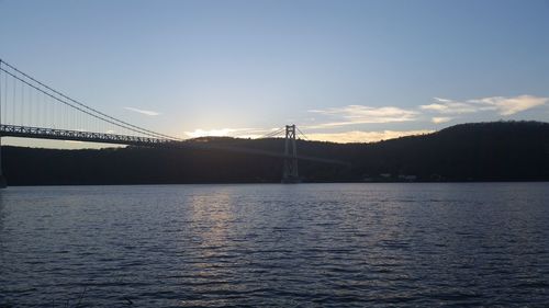 View of bridge over river during sunset