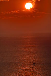 Scenic view of dramatic sky over sea during sunset