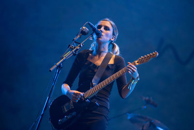 Man playing guitar at music concert