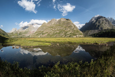 Scenic view of lake and mountains against sky