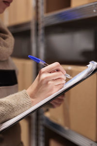 Cropped hand of woman using mobile phone