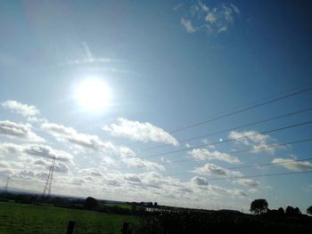 Low angle view of bright sun in sky