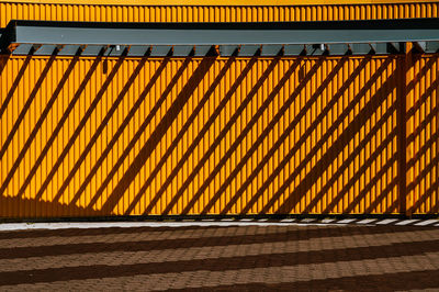 Orange wall with shadows, coney island boardwalk, brooklyn.