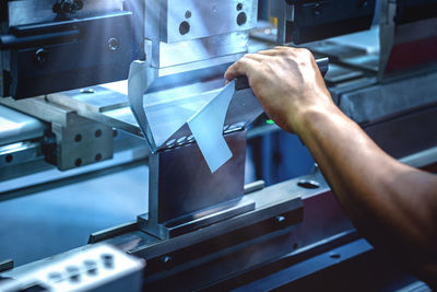 High angle view of man working on metal