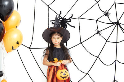 Full length portrait of girl standing on footpath during halloween