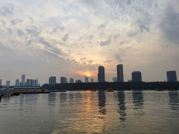 Scenic view of buildings against sky during sunset