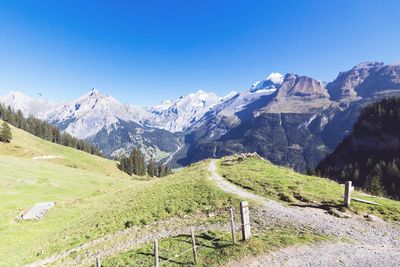 Scenic view of mountains against clear blue sky