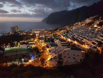 High angle view of illuminated cityscape against sky