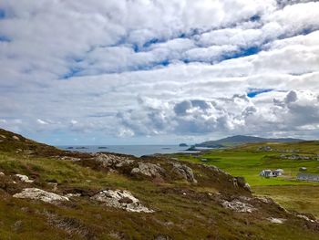 Scenic view of sea and mountains against sky