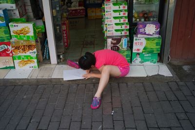 Full length of woman standing on footpath