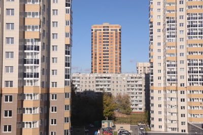 Buildings in city against clear sky