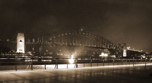 Ferris wheel at harbor in city at night
