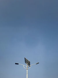 Low angle view of street light against clear blue sky