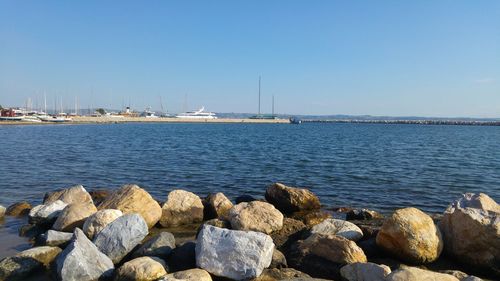 View of boats in sea against clear sky