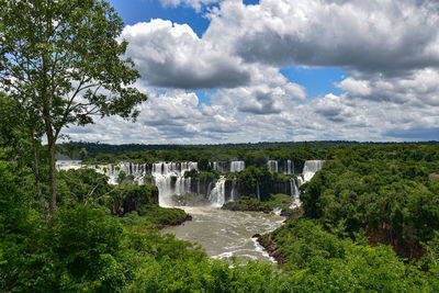 Scenic view of waterfall against sky