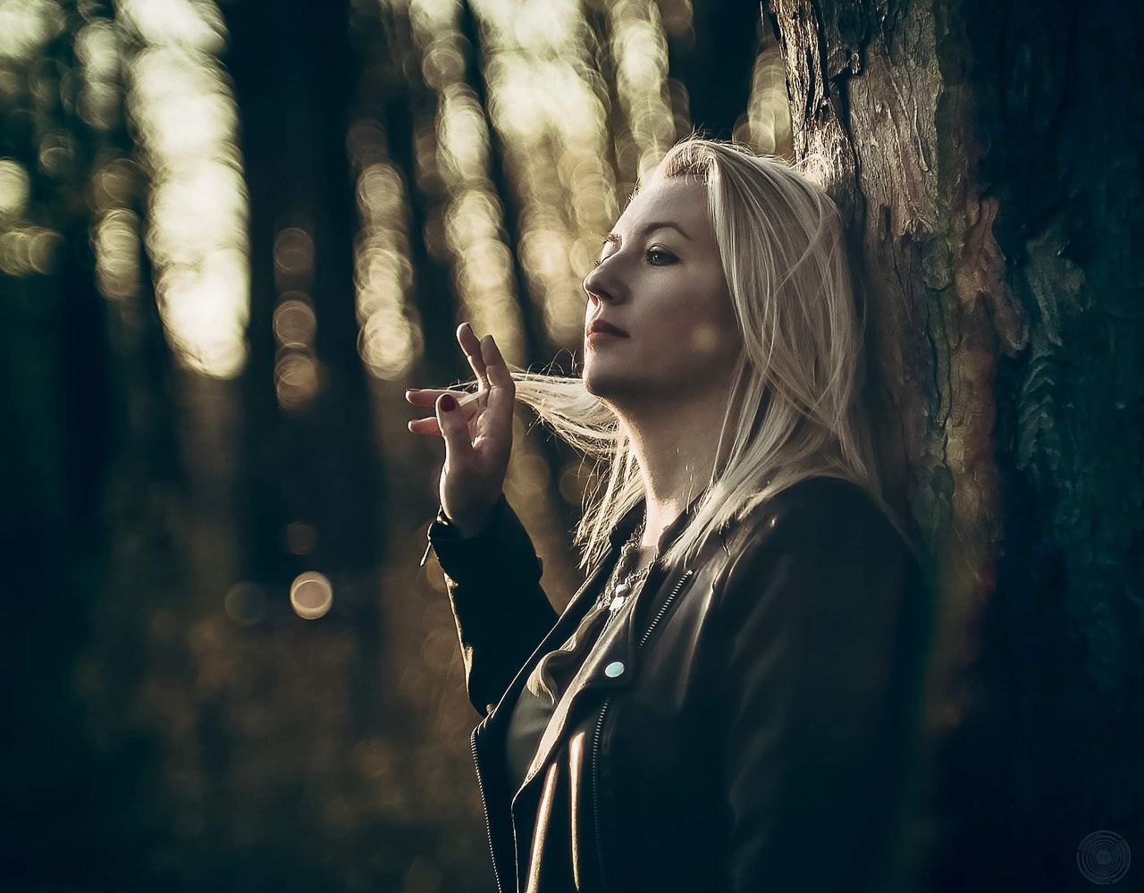 darkness, one person, women, adult, tree, young adult, nature, forest, blond hair, portrait, lifestyles, plant, light, female, smoking, land, leisure activity, hairstyle, outdoors, long hair, looking, contemplation, person, sunlight, social issues, activity, emotion, waist up, smoking issues, side view