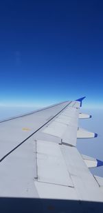 Airplane flying against clear blue sky