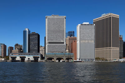 Modern buildings in city against clear blue sky