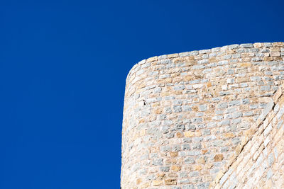 Low angle view of building against clear blue sky