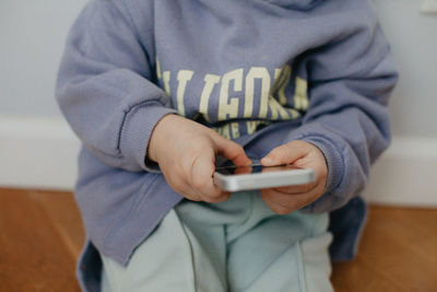 Midsection of man using mobile phone