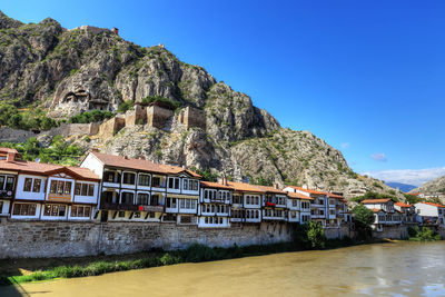 Building by mountains against clear sky