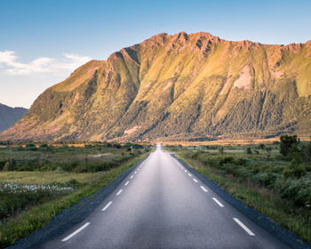 Road amidst mountains against sky