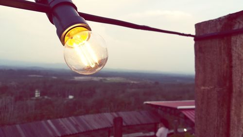 Close-up of light bulb against sky